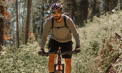 lifestyle image of a man riding his bicycle 